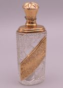 A Continental 18 ct gold and cut crystal glass scent bottle. 9 cm high.