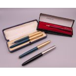 Three Parker fountain pens, one with 14 ct gold nib, and two pencils.