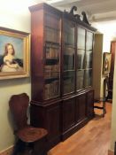 A near pair of early 19th century and later mahogany breakfront bookcases (one probably made to