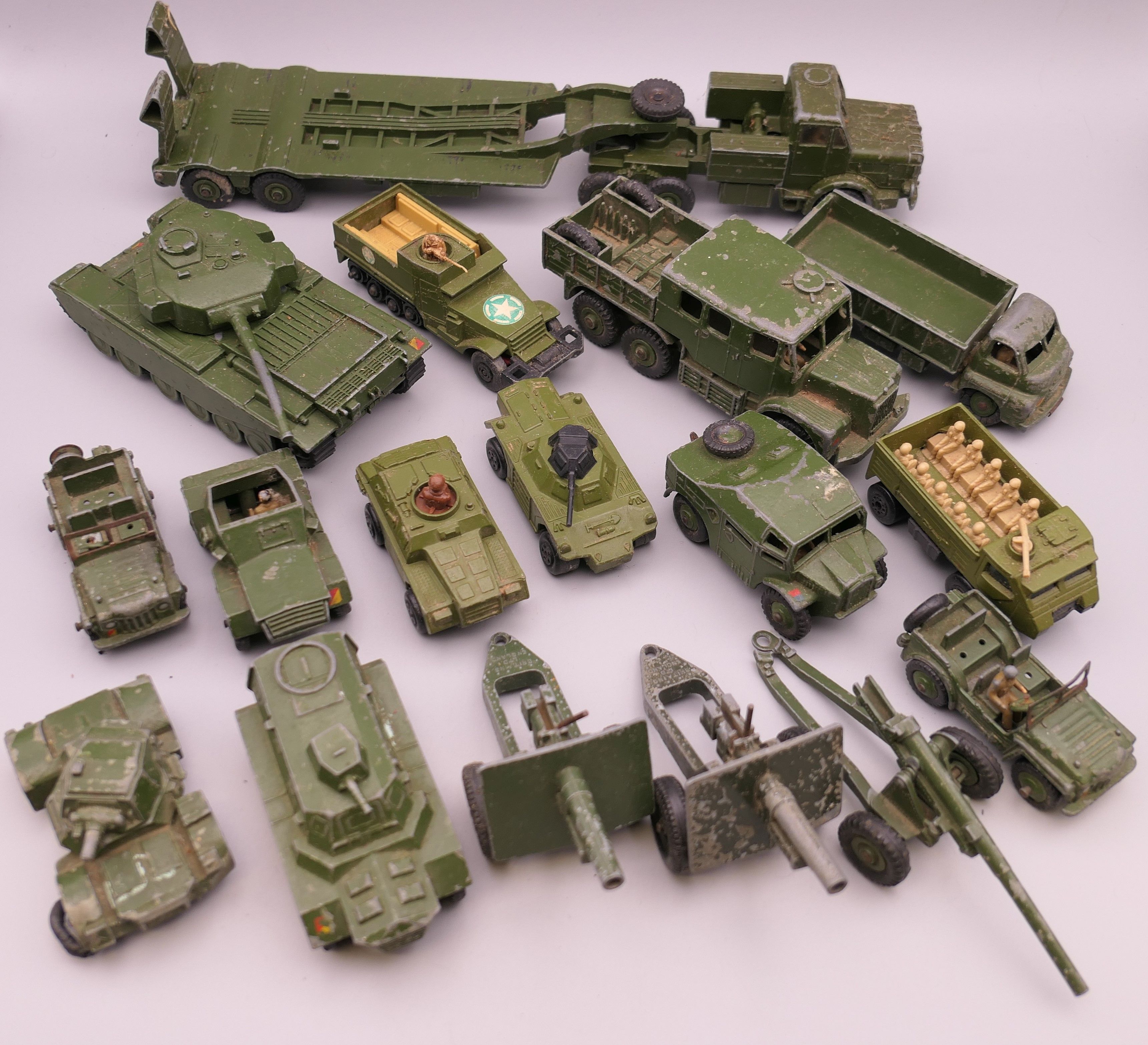 A quantity of various die cast military vehicles and cannons, including Dinky and Matchbox.