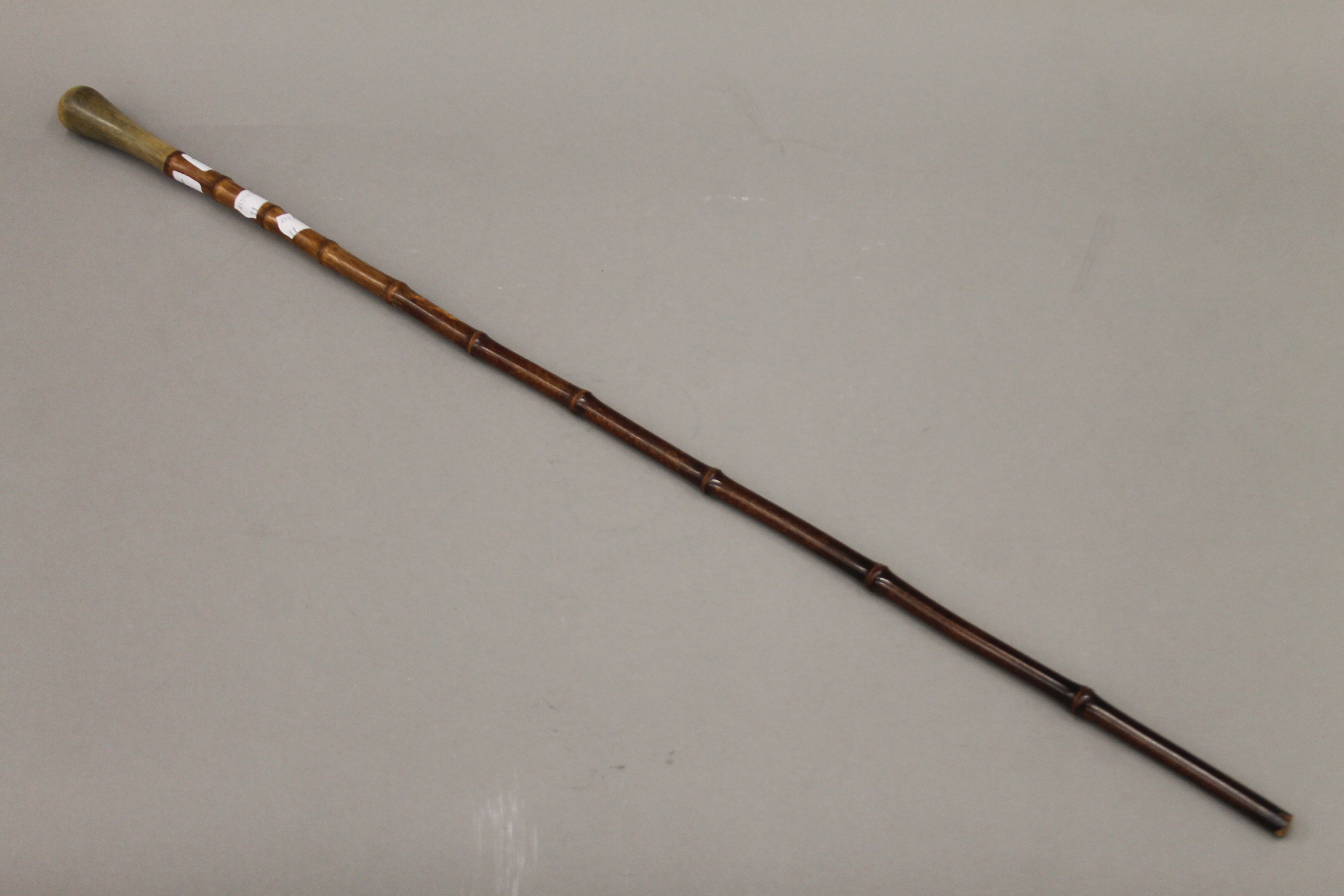 A 19th century bamboo walking cane, the handle possibly rhino horn. 79 cm long.