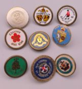 Nine golfing lapel badges. Largest 2 cm diameter.
