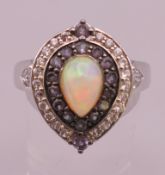 A silver, opal and cubic zirconia ring. Ring size V/W.
