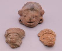 A small quantity of antiquity type pottery masks. Largest 5 cm high.