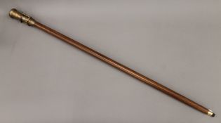 A walking stick mounted with a telescope/compass. 99 cm long.