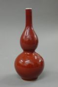 A Chinese sang de boeuf double gourd porcelain vase. 16.5 cm high.