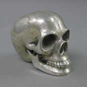 A silver plated model skull. 9 cm high.