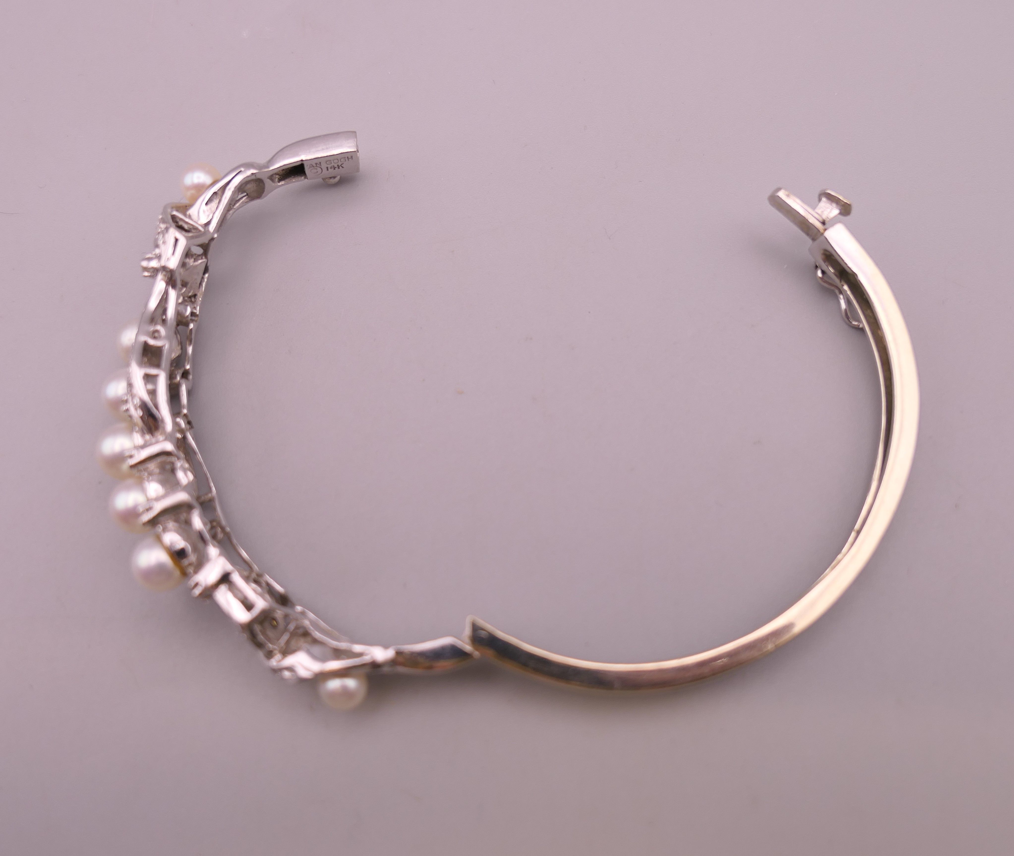 A 14 K white gold diamond and pearl bangle. 5 cm internal diameter. 16.5 grammes total weight. - Image 7 of 7