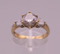 A 9 ct gold and cubic zirconia three stone ring. Ring size L. 2.4 grammes total weight.