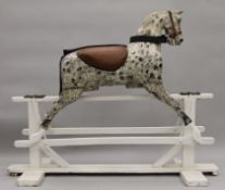 A late 19th/early 20th century painted wooden rocking horse. 161 cm long.