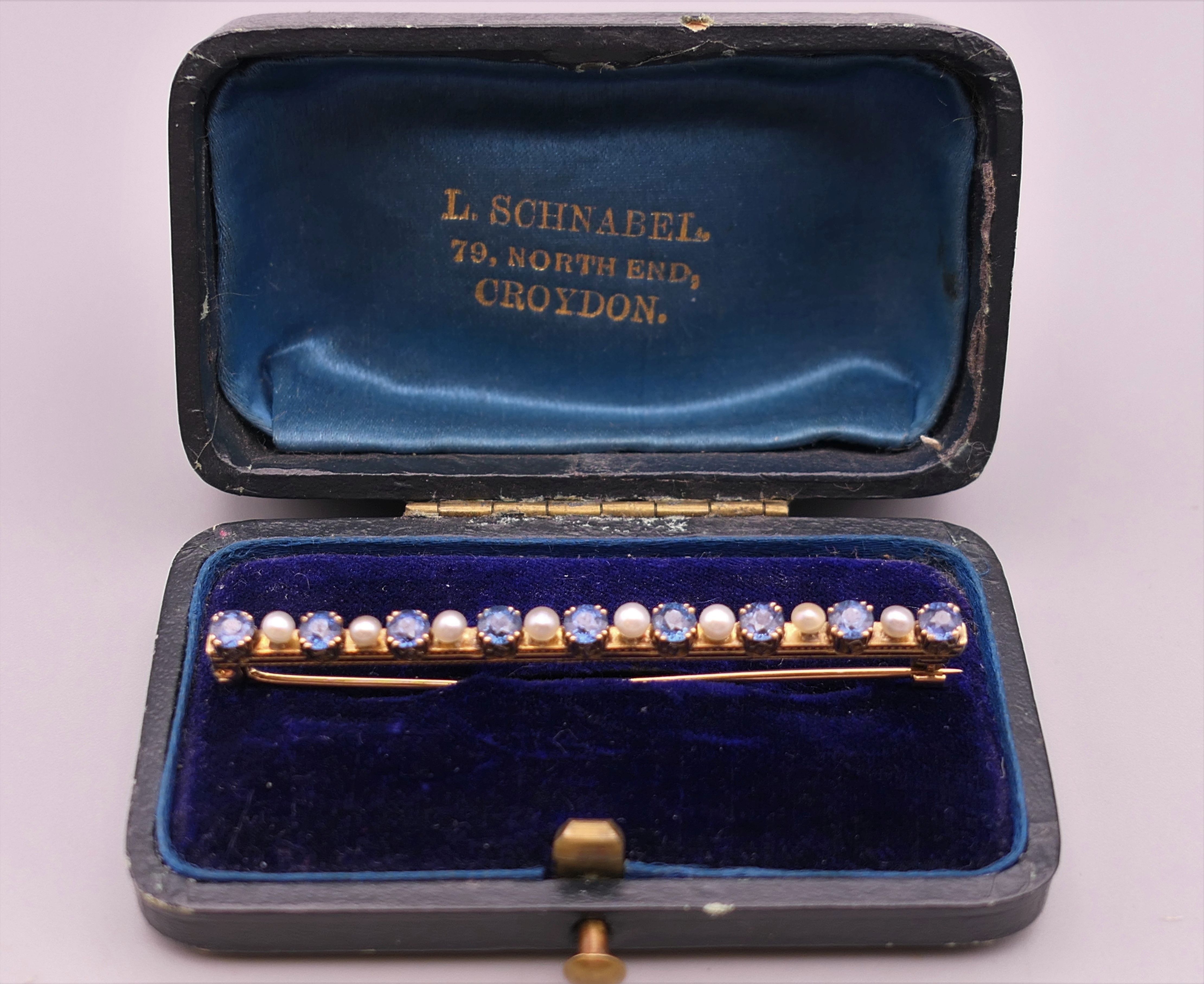 An antique natural sapphire and seed pearl unmarked gold (high carat tested) brooch, boxed. - Image 9 of 10