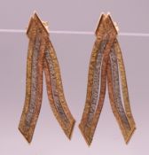 A pair of 14 K gold earrings. 1.6 grammes.