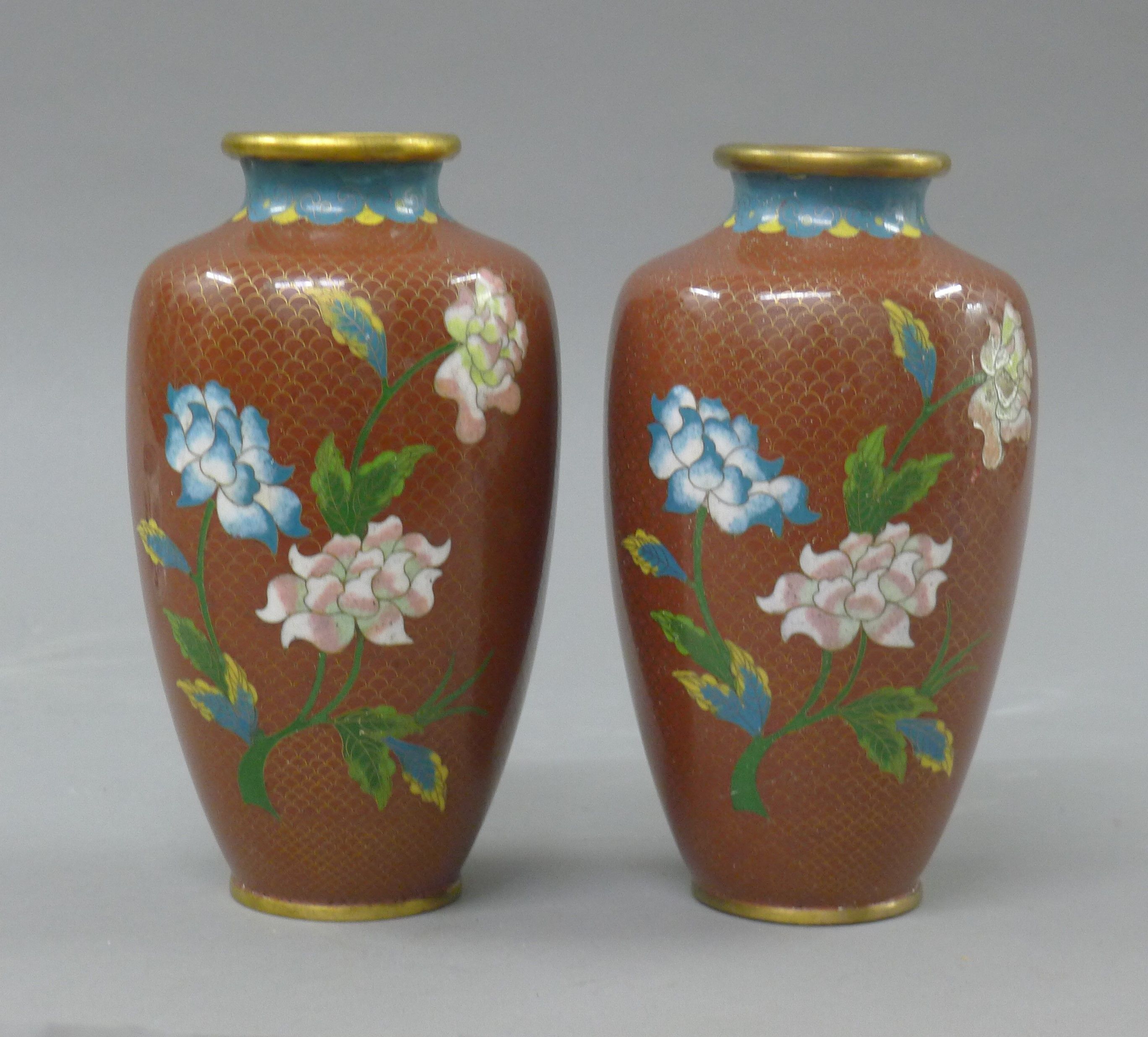 A pair of red cloisonne vases. 18 cm high.