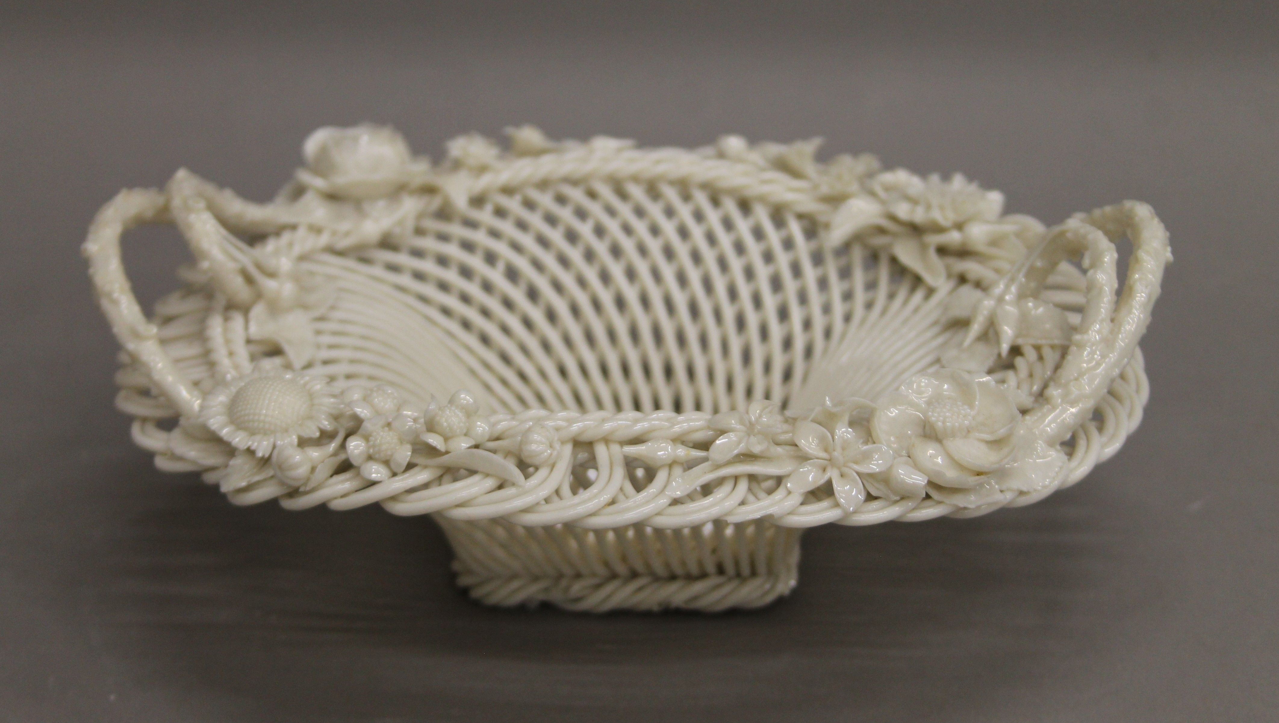 A Belleek porcelain basket. 20.5 cm long.