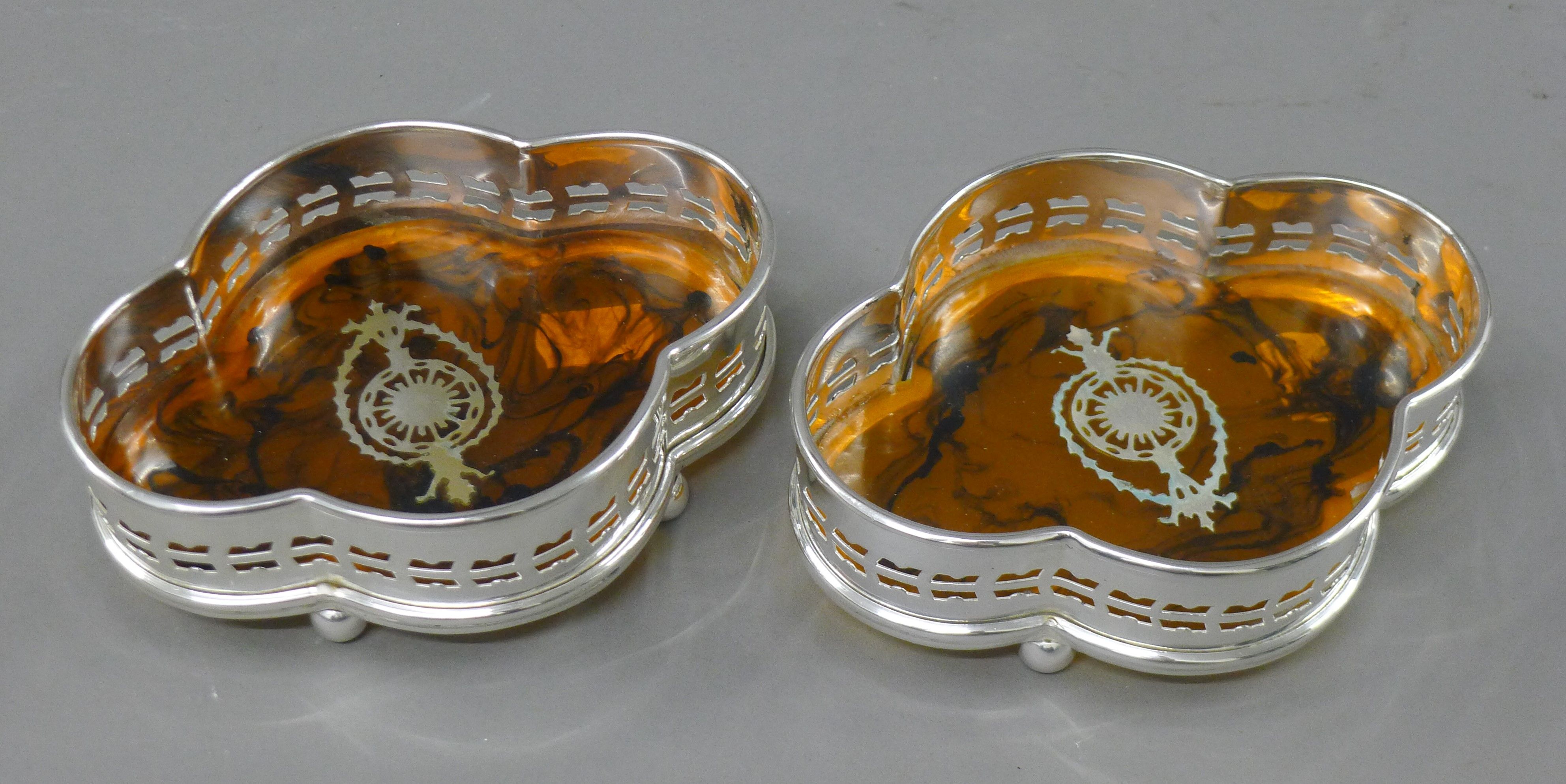 A pair of silver plated coasters. 15 cm wide.