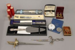 A quantity of coins, silver handled cake knives, etc.