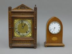 An Edwardian inlaid mahogany mantle clock and an oak mantle clock.