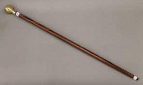 A walking stick, the handle formed as a globe. 93 cm long.