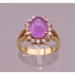 An 18 ct gold cabochon ruby and diamond ring. Ring size M.