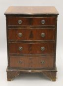 A 20th century serpentine chest of drawers. 54 cm wide.