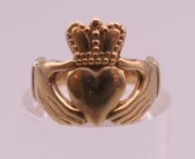 A 9 ct gold Claddagh ring. Ring size F/G. 2.1 grammes.