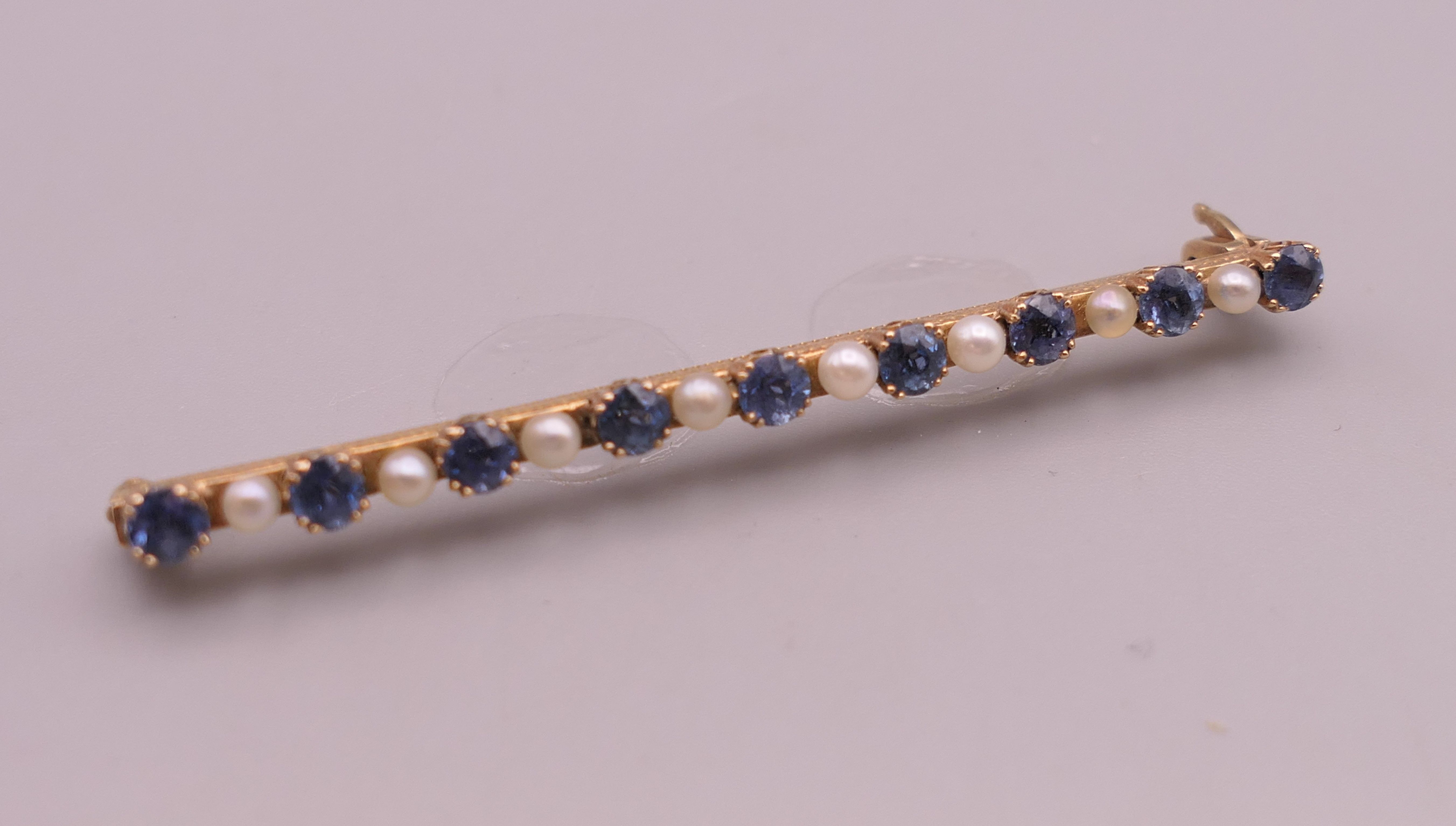 An antique natural sapphire and seed pearl unmarked gold (high carat tested) brooch, boxed. - Image 3 of 10