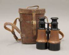 A pair of leather cased WWI binoculars, the leather cased stamped for T French & Son Ltd, London.