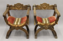 A pair of carved X-frame open armchairs. 61 cm wide.