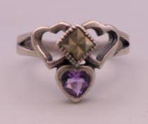 A silver and amethyst Claddagh ring. Ring size N.