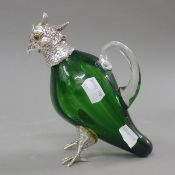 A silver plate and green glass parrot form jug. 15 cm high.