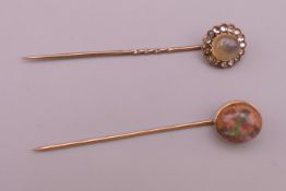 Two unmarked gold stick pins, one set with opal and the other with moonstone. 6.5 cm long. 5.