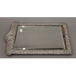 A large silver framed strut mirror. 49.5 cm high.