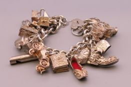 A silver charm bracelet. Approximately 20 cm long. 101.3 grammes total weight.