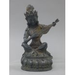 A Chinese bronze model of Guanyin playing a musical instruments. 21.5 cm high.