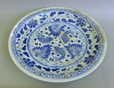 A large Chinese porcelain blue and white charger. 60 cm diameter.