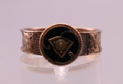 A 9 ct gold mourning ring. Ring size P. 2 grammes total weight.