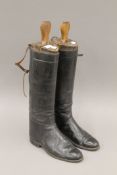 A pair of vintage leather riding boots and boot trees.