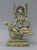 An Eastern bronze model of a multi-armed deity seated on a bird. 25 cm high.