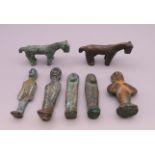 Seven early bronze and iron votive figures. The largest 7 cm high.