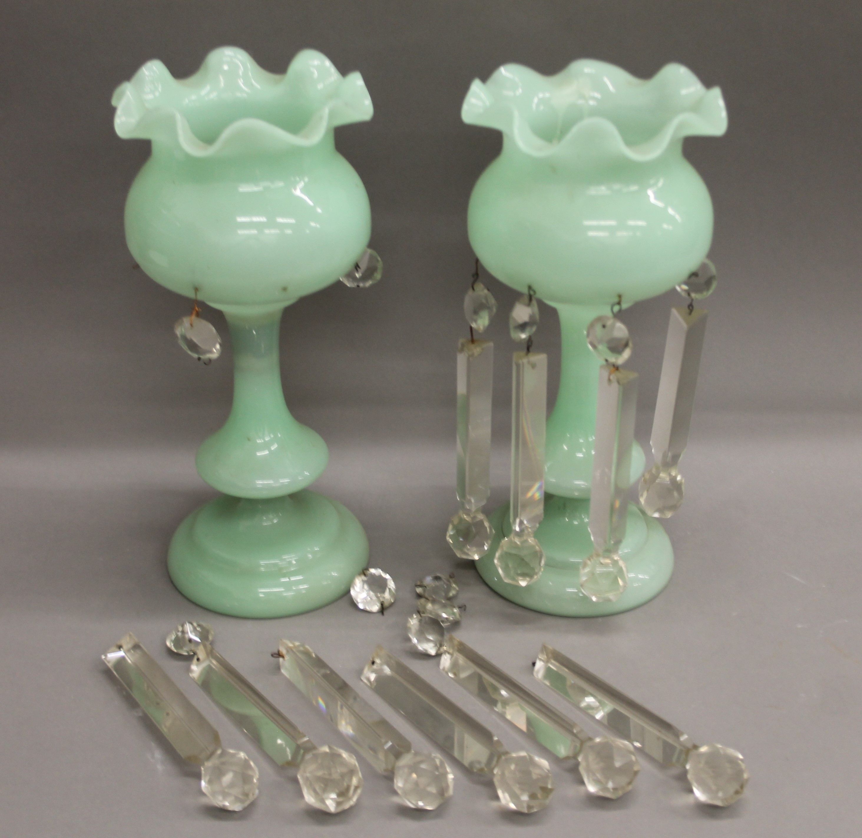 A pair of Victorian green glass lustres. 33 cm high.