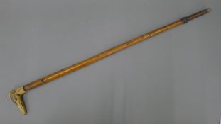 A Victorian walking stick, the antler handle formed as a greyhound. 80 cm long.