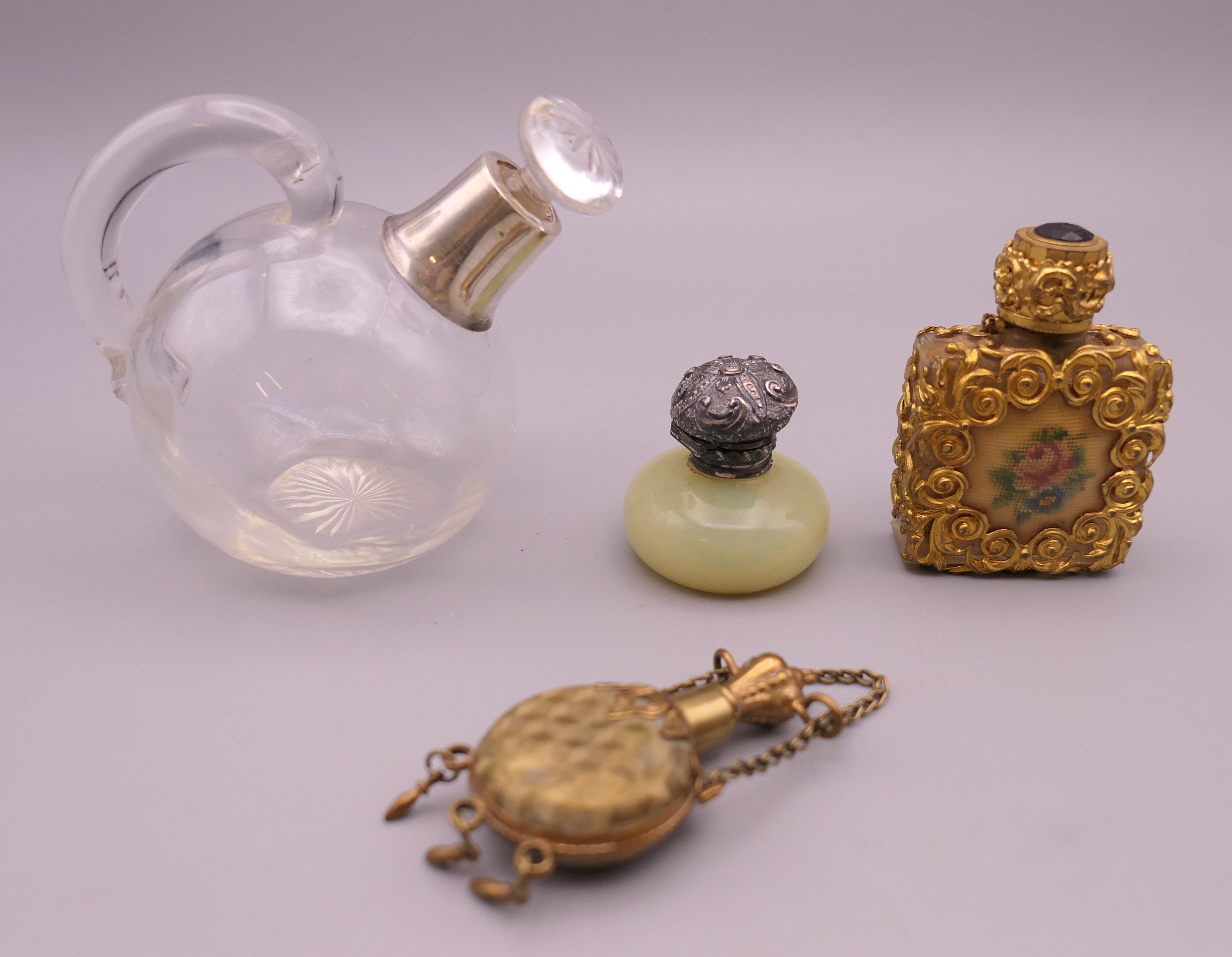 Four vintage perfume/scent bottles. Largest 8 cm high.