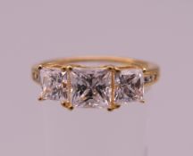 A silver gilt three stone cubic zirconia ring. Ring size Q.