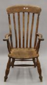 A Victorian elm seated splat back armchair. 61 cm wide.