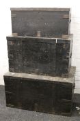 A set of three 19th century black painted campaign trunks. The largest 100 cm wide.
