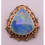 A 14 K gold opal brooch/pendant. 3.5 cm high. 13.3 grammes total weight.