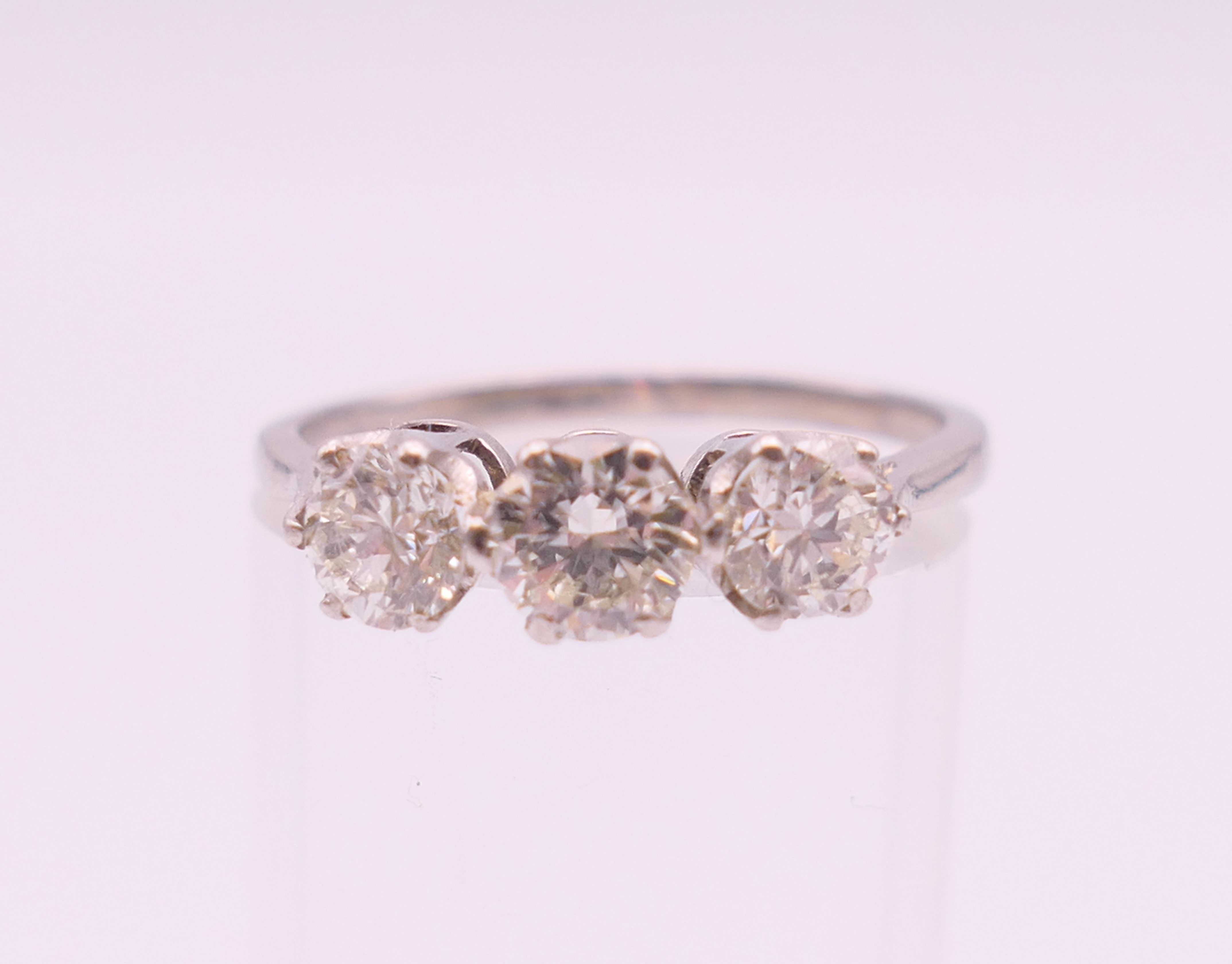 A platinum diamond trilogy ring. The total diamond weight approximately .8 carat. estimate. - Image 2 of 8