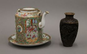 A Chinese famille rose plate, a teapot and a vase. The former 20 cm diameter.
