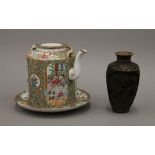 A Chinese famille rose plate, a teapot and a vase. The former 20 cm diameter.