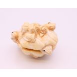 A bone carving formed as frogs. 3.5 cm high.